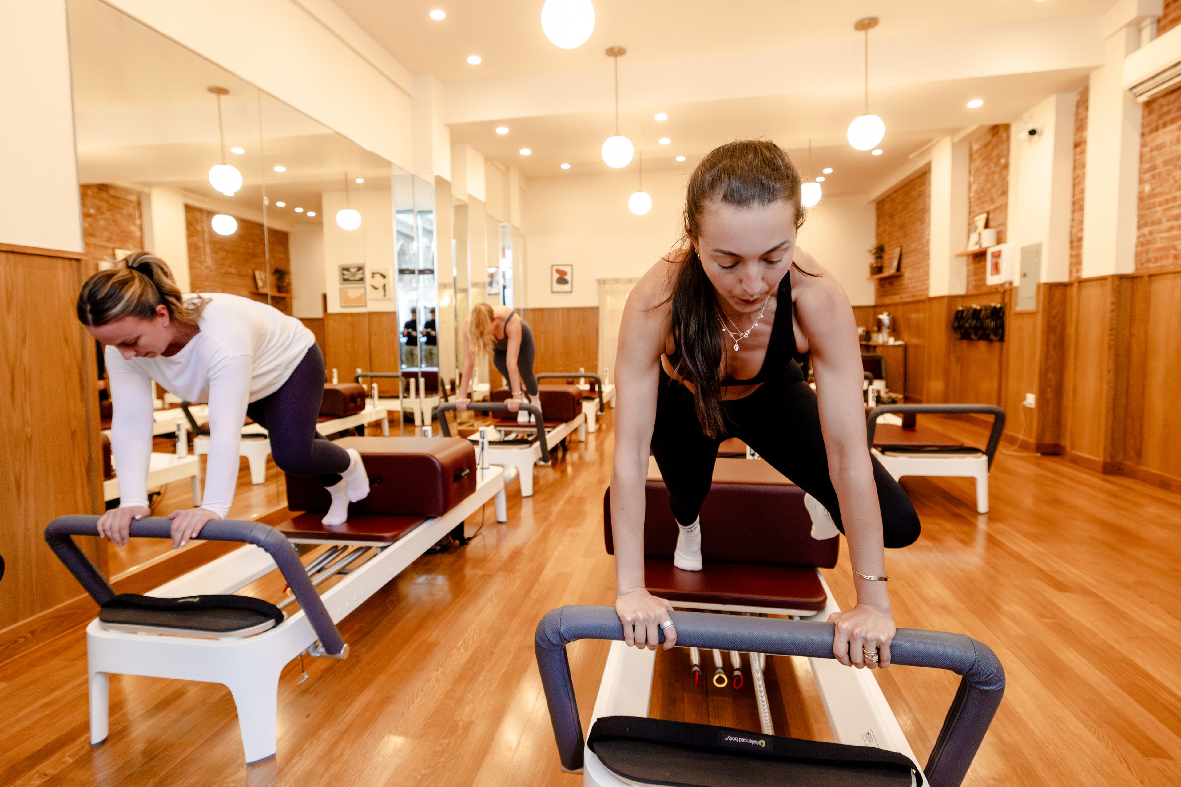 Women doing reformer pilates